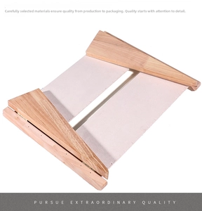 Macro view of folding wooden necklace stand with beige canvas and metal hinge detail