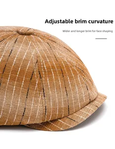 Close-up of brown striped newsboy cap with adjustable foldable brim and textured fabric
