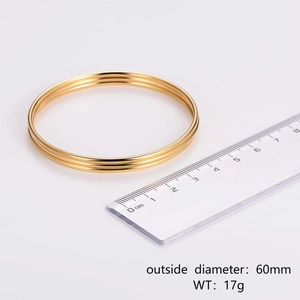 Gold stainless steel triple stacked bangle bracelets shown with a 60mm diameter measurement
