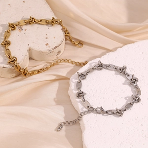 Detail of 14K gold and silver plated coffee bean knot chain bracelets with lobster clasp