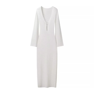 Detailed view of white knit dress featuring a deep V-neck and metal ring buckle detail