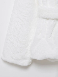 Close-up of white faux fur texture showing soft plush fibers on fashion coat