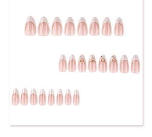 Detailed flat lay of almond-shaped press-on nails with white marble tips and gold bows