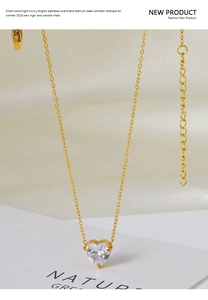 Close-up of gold titanium steel heart pendant necklace with zircon stone and lobster clasp