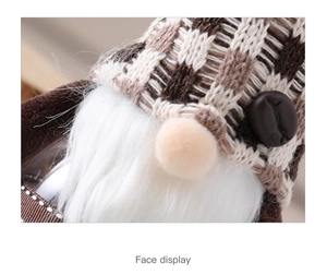 Close-up of a Christmas gnome doll featuring brown plaid knit texture and soft white beard