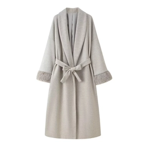Detail of light gray long wool coat featuring faux fur cuffs and a waist tie belt