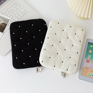 Padded quilted laptop sleeves featuring black and white polka dots for stylish protection