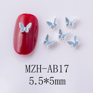Detailed macro view of 5.5x5mm light blue alloy butterfly nail art charms with silver edges