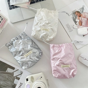 Glossy butterfly embossed drawstring pouch for cameras in white, silver, and pink