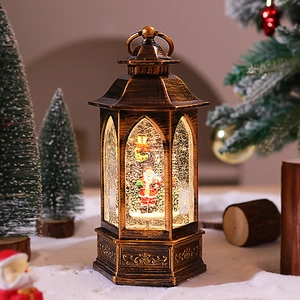 Macro view of vintage bronze Christmas lantern with Santa scene and glowing snow effect