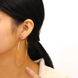 Exaggerated large golden round hoop earrings in polished stainless steel for women