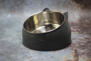 Detail of slanted black cat-ear pet bowl with removable stainless steel inner bowl