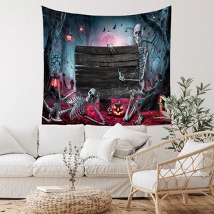 Halloween wall tapestry with skull and pumpkin design hanging over a sofa in a cozy room