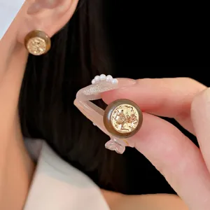 Vintage round brown resin stud earrings with gold embossed portrait on silver pins
