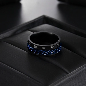 Detailed macro view of black titanium ring featuring blue rotatable chain and Roman numerals