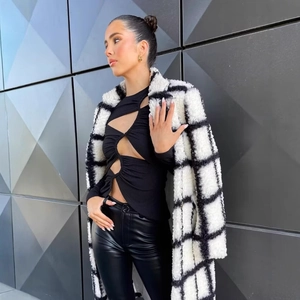 Chic black and white checkered plush long coat with collar for a stylish winter look