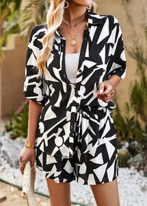 Close-up of black and white geometric print set with button-up shirt and drawstring shorts