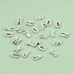 Detailed view of mirror-polished silver titanium steel alphabet beads with 1.8mm small holes