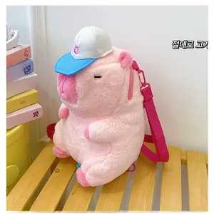 Detailed shot of pink plush capybara backpack with blue hat on wooden bench