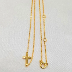 Detailed macro view of an adjustable gold-plated S925 silver cross pendant necklace