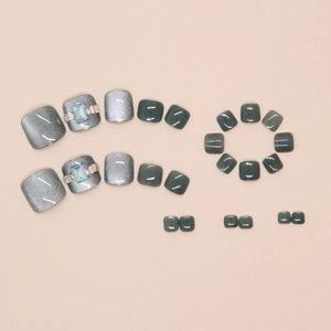 Macro shot of grey cat eye toe nail press-ons with luxury rhinestone decorations