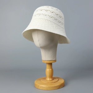 Chic hollow knit fisherman bucket hat in off-white displayed on a wooden stand
