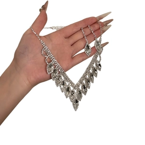 Elegant silver-colored V-shaped necklace and teardrop tassel earrings jewelry set with crystals