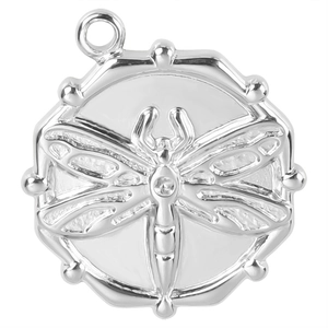 Macro shot of silver round dragonfly pendant with beaded edge and embossed details