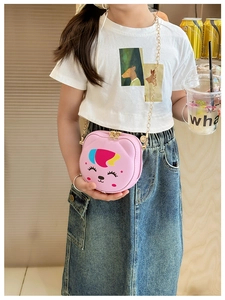 Pink cartoon animal crossbody bag with gold chain strap worn by a young child