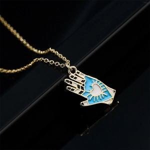Unique 18K gold plated palm pendant necklace with blue heart enamel on black background