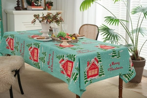 Detailed texture of cotton linen tablecloth with festive house and Christmas tree patterns