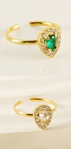 Detail of 18K gold adjustable rings featuring green and white teardrop zircons