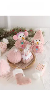 Pink Christmas ornaments collection featuring plush snowmen, velvet balls and stockings