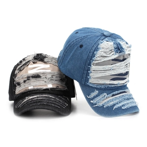 Distressed denim baseball caps with vintage ripped details and letter prints in black and blue