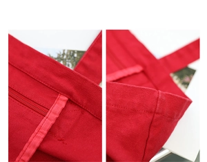 Detailed macro view of red canvas tote bag showing interior zipper and reinforced stitching
