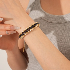 Detail of vintage beaded bracelet with purple crystals and white pearls on wrist