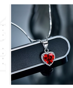 Macro shot of S925 sterling silver heart ruby pendant with shimmering white zircon halo