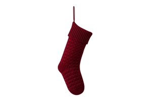 Close-up of deep red knitted Christmas stocking with intricate textured stitch patterns