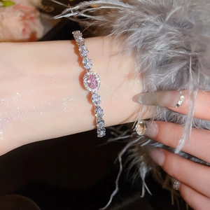 Detail view of luxury pink oval gemstone bracelet with sparkling white zircon settings