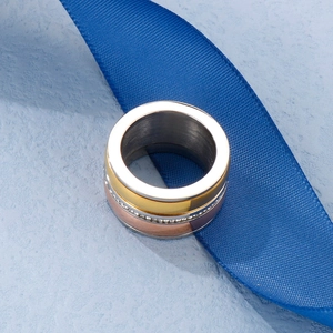 Detailed close-up of triple-layered ring in gold, rose gold and silver with white zircon