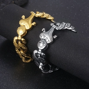 Detail of punk titanium steel bracelets with Egyptian hieroglyphs in gold and silver