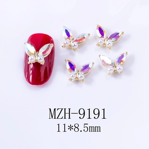 Detail view of 3D butterfly nail charms with aurora effect and faux pearls size 11x8.5mm