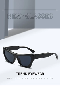 Detail of black cat-eye sunglasses with wide temples and dark grey lenses for fashion