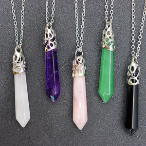 Detailed view of hexagonal natural crystal pendants with hollow silver-tone metal caps