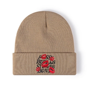 Detailed close-up of rose buds strong bond embroidery on khaki knit beanie
