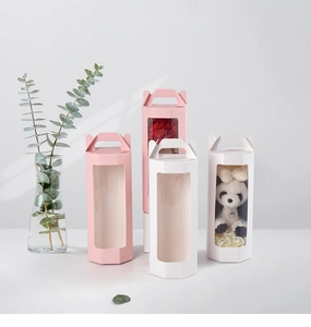 Pink and white hexagonal gift boxes with transparent windows for flowers and dolls