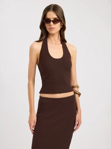 Detail of dark brown ribbed knit two-piece set with halter neck top and maxi skirt