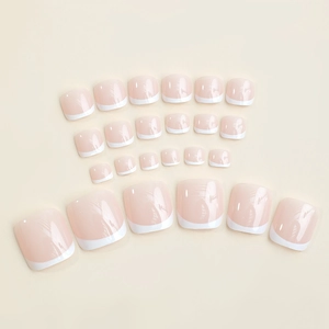 French tip press-on toenails in nude and white finish, 24 pieces set on neutral background