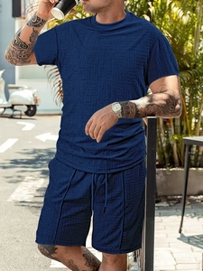 Detail showing breathable waffle texture of dark blue summer polo and shorts set