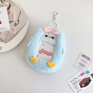 Detail of blue plush penguin photocard holder with clear window and pink bow accent